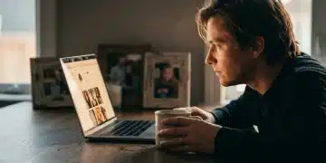 A person, illuminated by a laptop screen displaying a celebrity's social media, rests a hand on a mug on a dark oak table, suggesting a deep parasocial connection. High-contrast documentary style with warm tones.